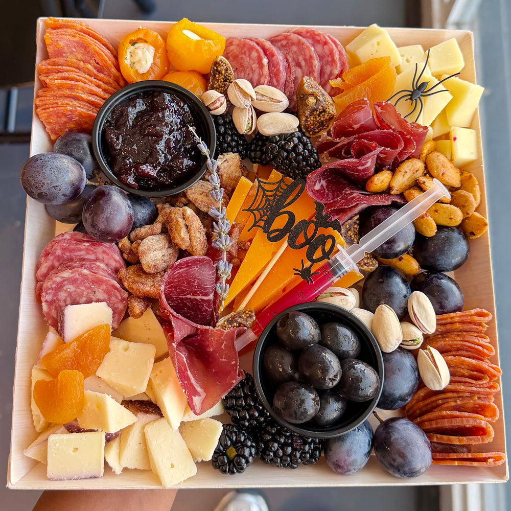 Halloween-themed charcuterie board with seasonal decorations